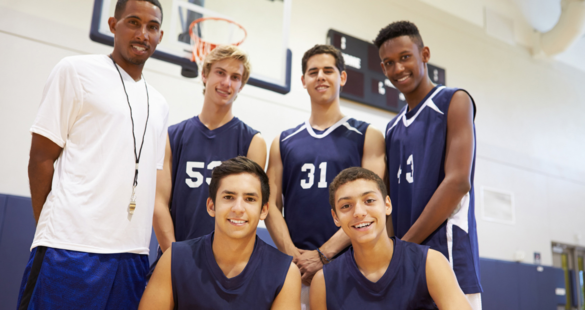 Members Of Male High School Basketball Team With Coach